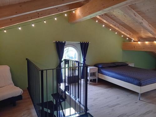 a bedroom with a bed and a staircase with lights at Villa Aurora in Torre Pellice