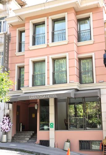 a pink building with the entrance to the savoy hotel at Saratoga Hotel Sultanahmet in Istanbul
