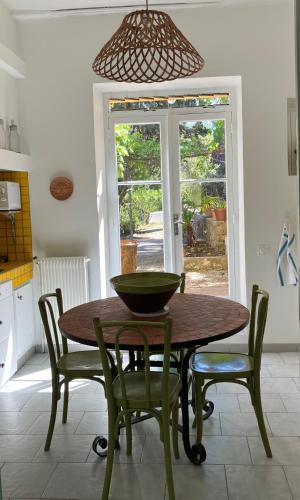 a kitchen with a table with chairs and a bowl on it at Casa sardine in Cassis