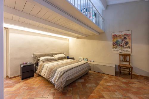 a bedroom with a large bed and a staircase at Il Nido di Bianca - Goelba in Portoferraio