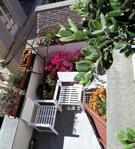 an apartment balcony with a bunch of plants and flowers at The sea you can feel in Aci Castello