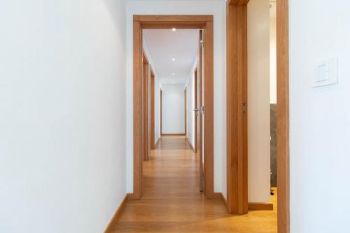 a hallway with wooden floors and white walls at Akicity Jamor Selected in Cruz Quebrada