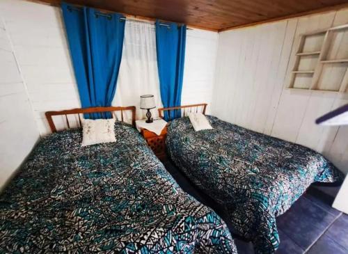 Cama ou camas em um quarto em Cabañas playa las cadenas