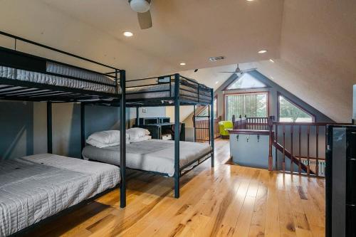 a bedroom with two bunk beds and a staircase at Rock and Roll River House in Jeffersonville