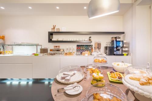 a kitchen with a table with many plates of food at On The Rock in Arco