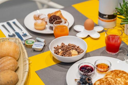 a table topped with plates of breakfast foods and drinks at On The Rock in Arco