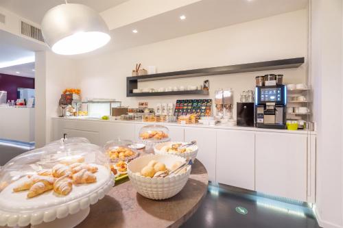 a kitchen with a table with baskets of pastries at On The Rock in Arco