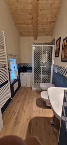 a bathroom with two sinks and two toilets at Villa Aurora in Torre Pellice