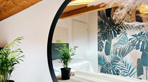 a mirror in a room with plants on the wall at Ferienwohnungen Krüger 'Apartment Moni' in Michelstadt