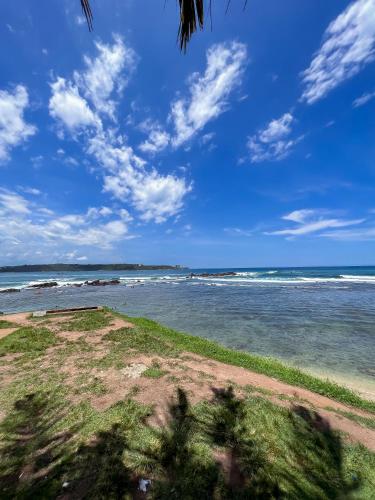 a view of the ocean on a sunny day at Light House View Inn - Galle Fort in Galle