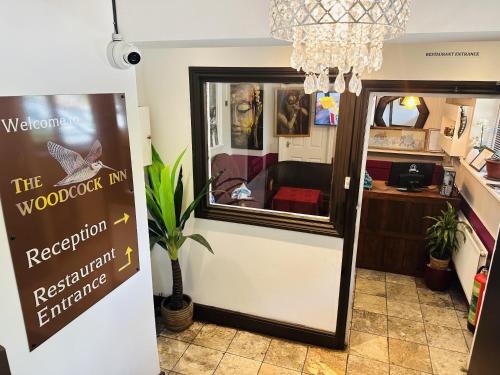 a shop with a sign in front of a door at woodcock inn in Felbridge