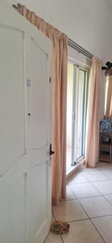 an open door in a room with a window at Grenadier A in Flic-en-Flac
