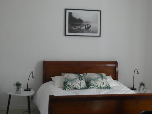 a bedroom with a bed with a picture on the wall at Maison Morin in Aups