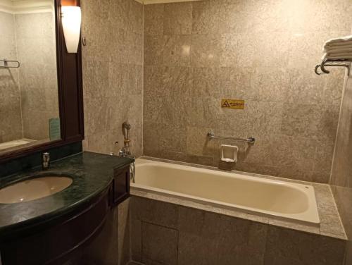 a bathroom with a bath tub and a sink at The Hotel and Apartment At Times Square in Kuala Lumpur