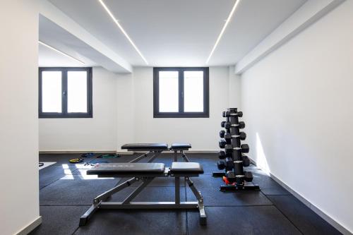 a gym with two treadmills and weights in a room at Athens Sea Side Escape in Vari