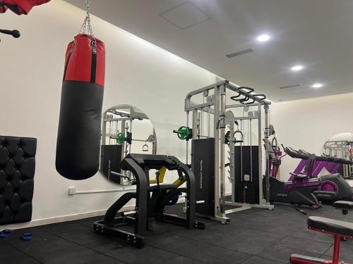 a gym with a punching bag hanging on the wall at Lara Hotel in Duhok