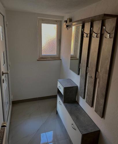 a bathroom with a sink and a mirror and a window at Comfortable 2 Bedroom Apartment Stuttgart &Ulm Area in Kuchen