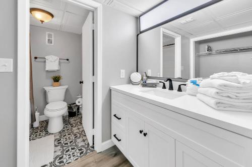 a white bathroom with a sink and a toilet at Edgewater Tower 2-108-Gunners Paradise in Panama City Beach