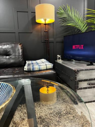 a living room with a glass table and a couch at Cozy Haven! in Edmonton
