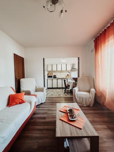 a living room with a couch and a table at Elena Apartment- Spacious for 6, 2 Bathrooms, Free Parking in Rovinj