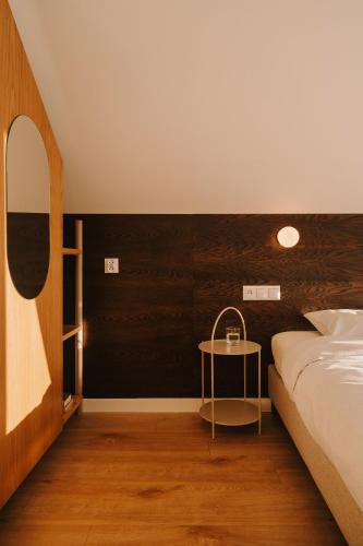 a bedroom with a bed and a table in it at Boho Sfera in Kopalino