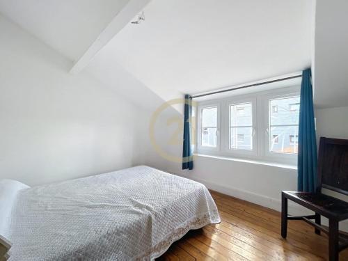 une chambre blanche avec un lit et une fenêtre dans l'établissement JO Family House, à Nanterre