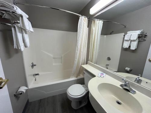 uma casa de banho com um WC branco e um lavatório. em Motel 6 Idabel, OK em Idabel
