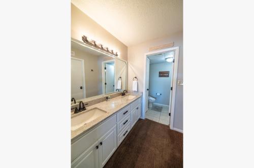 een badkamer met een wastafel en een grote spiegel bij Edgewater Villa 3105 'PCB1' in Panama City Beach