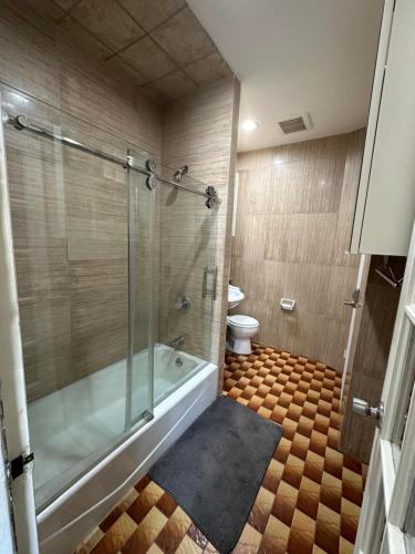 a bathroom with a tub and a toilet at Hudson Yard 408 in New York