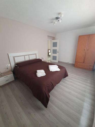 a bedroom with a large bed with two towels on it at villegas home in Granada