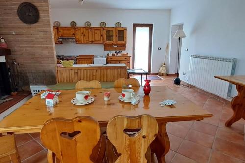 a kitchen with a wooden table and chairs in a room at Casa rustica con vista meravigliosa in Offida