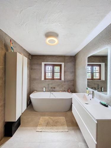 La salle de bains est pourvue d'une grande baignoire et d'un lavabo. dans l'établissement Villa Vikel, à Vence