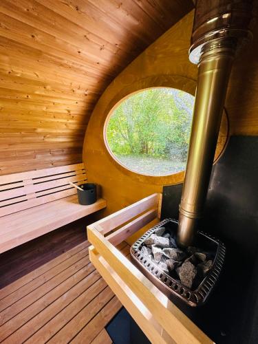 an inside view of a sauna with a round window at MANOIR DU VAU D ARZ gîtes et chambres d hôtes avec piscine in Malansac