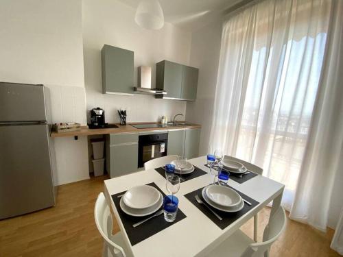 a kitchen with a table with plates and glasses on it at [Elce-Perugia] Brightest Condo 1 Km From The CityCenter in Perugia
