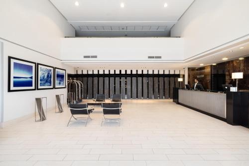 a lobby with a man sitting at a desk at Holiday Inn Santiago - Airport Terminal by IHG in Santiago