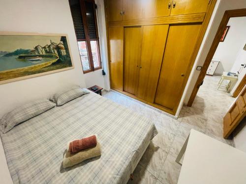 a bedroom with a bed and a painting on the wall at Alex Apartments in Benidorm