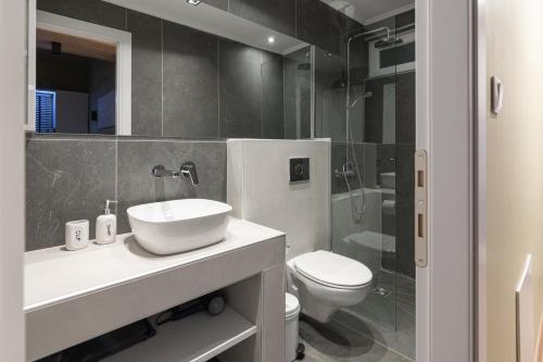 a bathroom with a sink and a toilet and a shower at No125 - City Centre Studio Apartment in Orestiada