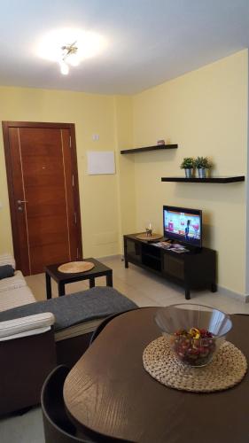 a living room with a table and a television at Piso Arrecife Centro in Arrecife