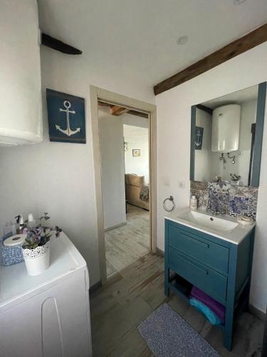 a bathroom with a blue sink and a mirror at casa típica asturiana in Avilés