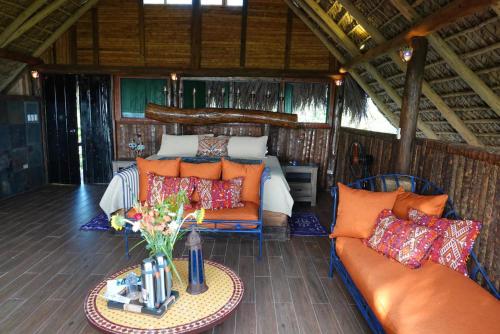 a living room with a couch and a table at Casa El Paraiso, Eco Lodge in Santa Bárbara de Samaná