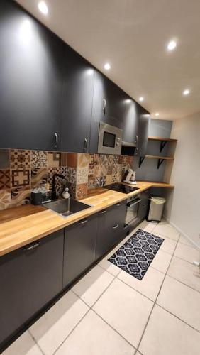 a kitchen with a sink and a counter top at Artiste in Douai