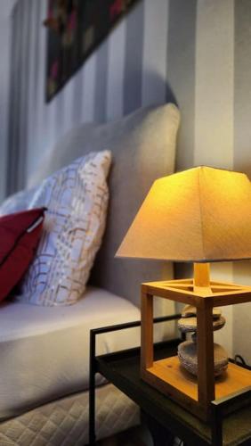 a lamp on a table next to a couch at Artiste in Douai