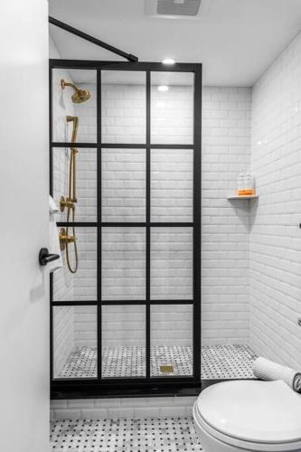 a bathroom with a shower with a toilet at Historic Hotel, King Bed, Market Square View, Room # 201 in Bangor