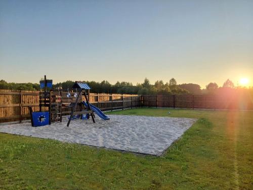 a playground with a slide in a yard at Boho Sfera in Kopalino
