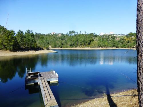 a dock in the middle of a lake at Casa do Bode in Levegada
