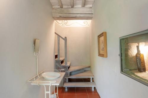 a small bathroom with a sink and a mirror at Borgo Casa al Vento in Gaiole in Chianti