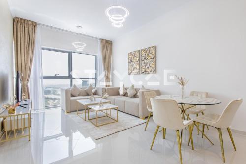 a living room with a couch and a table at Staycae Holiday Homes - Carson Towers in Dubai