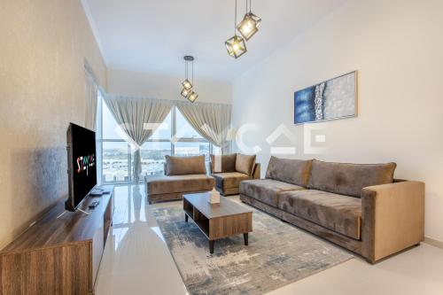 a living room with a couch and a tv at Staycae Holiday Homes - Carson Towers in Dubai