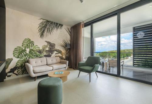 a living room with a couch and a table and chairs at Papagayo Beach Hotel in Willemstad
