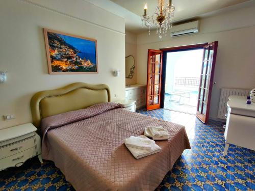 a bedroom with a bed with two towels on it at Casa La Scogliera in Praiano